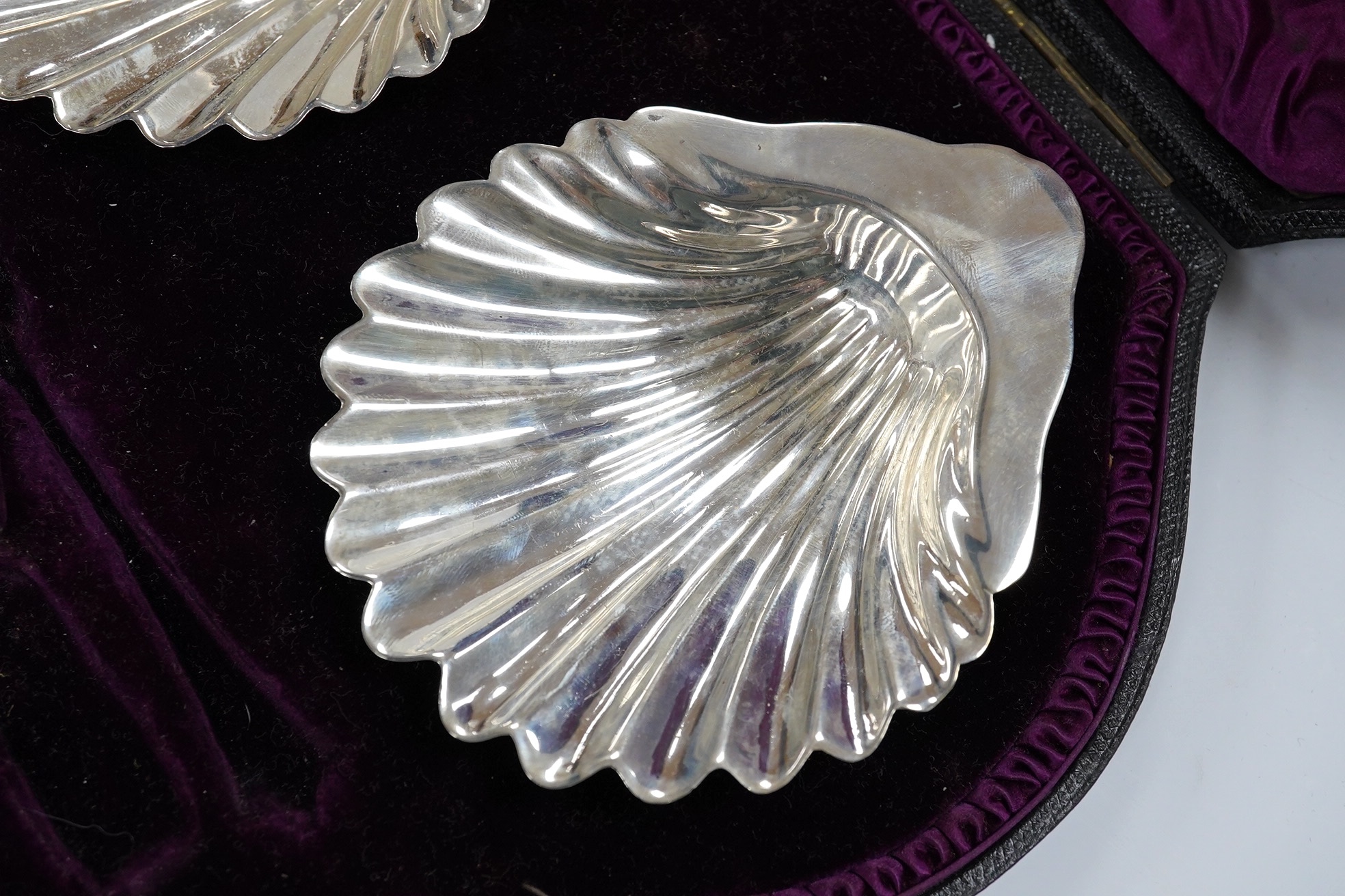 A cased pair of late Victorian silver butter shells, (lacking butter knives), John Newton Mappin, London, 1893. Condition - fair